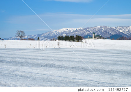 Snowy fields where snow-melting agents have been spread as spring approaches Snowy fields where snow-melting agents have been spread as spring approaches 135492727