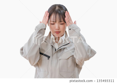 Female worker holding her head 135493311