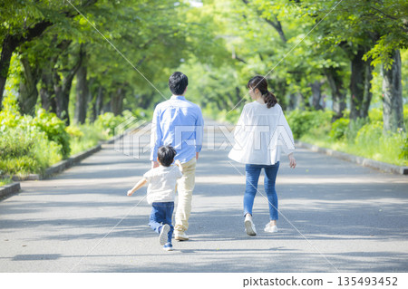 Family walking in the fresh green park 135493452