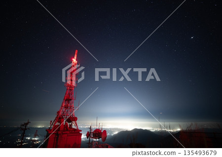 A photo of the starry sky and town lights from Mt. Wanizuka A photo of the starry sky and town lights from Mt. Wanizuka 135493679