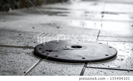 Round Industrial Drain Cover on Concrete Round Industrial Drain Cover on Concrete 135494101