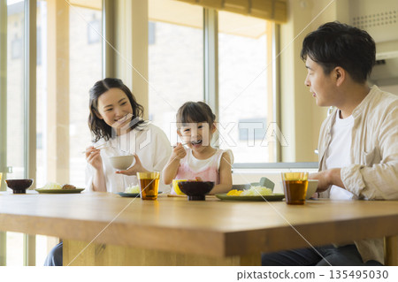 A happy family at the dinner table 135495030