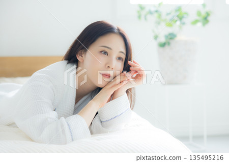 A woman relaxing at bed 135495216