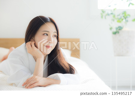 A woman relaxing at bed A woman relaxing at bed 135495217