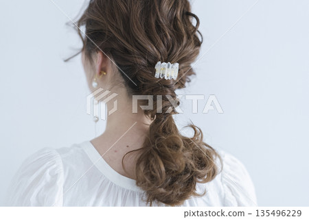 A back view of a girl with long black hair on a white background A back view of a girl with long black hair on a white background 135496229