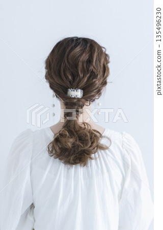 A back view of a girl with long black hair on a white background A back view of a girl with long black hair on a white background 135496230