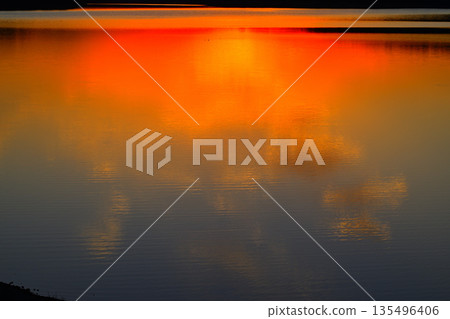 Sun reflection on the lake surface, Lake Sayama, view from the lakeside 135496406