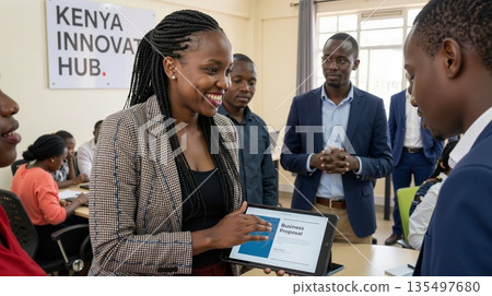 African woman entrepreneur presenting business proposal on tablet to colleagues 135497680