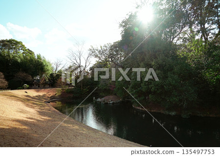 Japan Okayama Korakuen Ogawa-separated light-and-shadow ratio scenery, grass grass and forest-like water surface with sunlight fading away Japan Okayama Korakuen Ogawa-separated light-and-shadow ratio scenery, grass grass and forest-like water surface with sunlight fading away 135497753