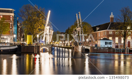 Picturesque Amsterdam Nightscape Illuminated Bridges and Reflections in the Canals of Amsterdam 135498073