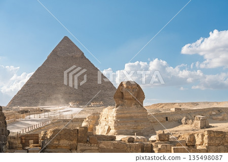 Ancient Egyptian Marvels Majestic Pyramid and Sphinx Giza Under a Blue Sky with Clouds Ancient Egyptian Marvels Majestic Pyramid and Sphinx Giza Under a Blue Sky with Clouds 135498087