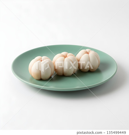 Mangosteen Fruit Arils Three on Clean Green Plate 135499449