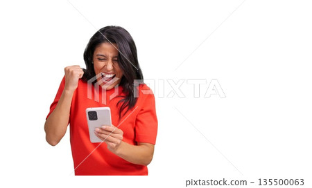 Woman winning and celebrating while checking smartphone Woman winning and celebrating while checking smartphone 135500063