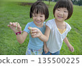 Children catching grasshoppers in the park 135500225