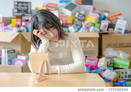 A woman struggling with a lot of products 135500344