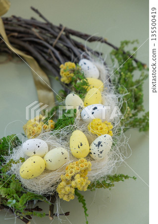 Handmade Easter wreath made of sustainable materials decorations in yellow color. Homemade decor Easter celebration gift present ideas. Copy space Handmade Easter wreath made of sustainable materials decorations in yellow color. Homemade decor Easter celebration gift present ideas. Copy space 135500419