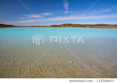 The Blue Lake appears along the main road on the outskirts of Reykjahlid, a town in the northern part of the Nordic island nation of Iceland. 135500425