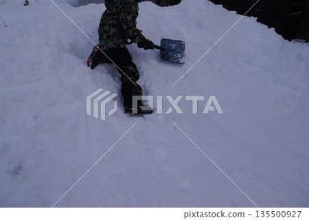 Child playing in the snow (no face) 135500927