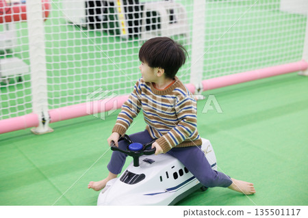 Boy playing with toy vehicles Boy playing with toy vehicles 135501117