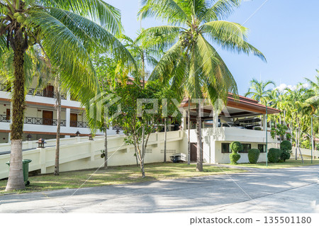 Hotel in palm trees in Thailand, close-up of the facade. Holidays in South Asian tropical resorts. High quality photo Hotel in palm trees in Thailand, close-up of the facade. Holidays in South Asian tropical resorts. High quality photo 135501180