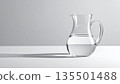 Glass pitcher on a pale gray background 135501488