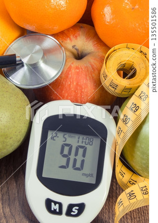 Glucometer with sugar level, fresh fruits, stethoscope and tape measure Glucometer with sugar level, fresh fruits, stethoscope and tape measure 135501586