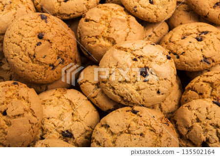 Cookies background. Chocolate chips biscuits texture background. Fattening sweets concept 135502164