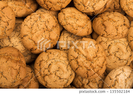 Cookies background. Oatmeal biscuits texture background. Fattening sweets concept Cookies background. Oatmeal biscuits texture background. Fattening sweets concept 135502184