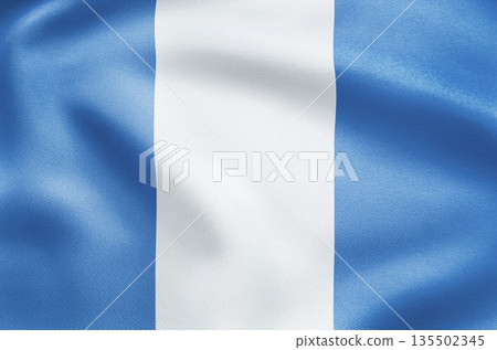 Elegant waving national flag of Guatemala with quetzal emblem and scroll. 135502345