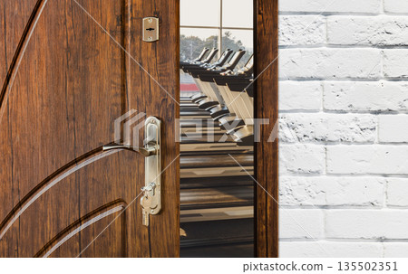 Opened door to gym interior with equipment. Entrance to fitness club with row of treadmills for fitness cardio training. Welcome to sport, healthy lifestyle concept Opened door to gym interior with equipment. Entrance to fitness club with row of treadmills for fitness cardio training. Welcome to sport, healthy lifestyle concept 135502351