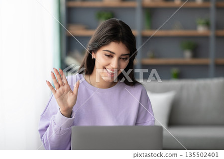 Online Meeting. Happy young woman using laptop computer for virtual conferencing, having video call at home. Cheerful millennial female communicating with colleagues, friends or psychologist remotely 135502401
