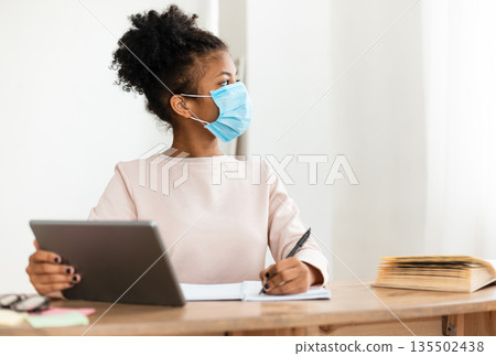 African Girl In Protective Face Mask Studying Using Tablet Computer In Classroom. Safe Back To School. Selective Focus 135502438