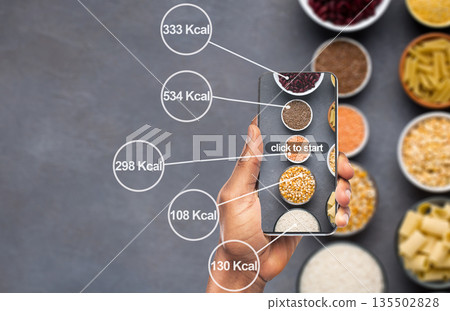 Losing weight easily. Cellphone counting amount of calories on background with cereals and pasta Losing weight easily. Cellphone counting amount of calories on background with cereals and pasta 135502828