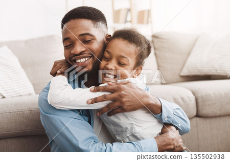 Warmth Hug. African Daughter Embracing Father With Love And Tenderness Warmth Hug. African Daughter Embracing Father With Love And Tenderness 135502938