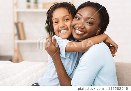 Loving African American Daughter Hugging Her Mom, Enjoying Time Together, Relaxing At Home Loving African American Daughter Hugging Her Mom, Enjoying Time Together, Relaxing At Home 135502946