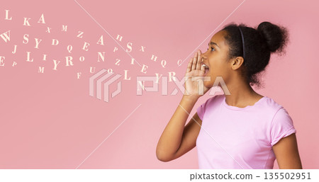 Gossip girl. African american teen screaming at copy space, diverse alphabet letters flying out of her mouth. Panorama 135502951