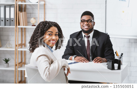 Smiling personnel manager and African American vacancy candidate on job interview in office. Panorama 135503051