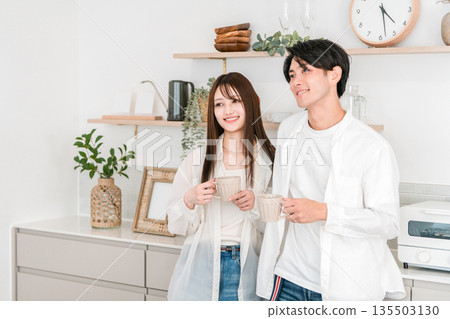 Couple drinking coffee in the kitchen at home, couple, new life, newlyweds 135503130