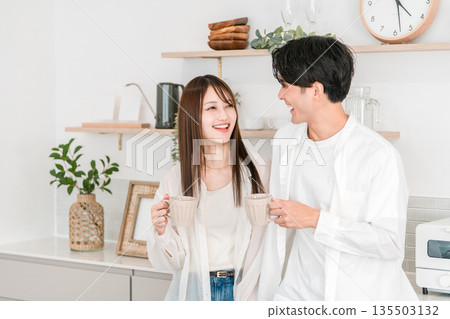 Couple drinking coffee in the kitchen at home, couple, new life, newlyweds 135503132