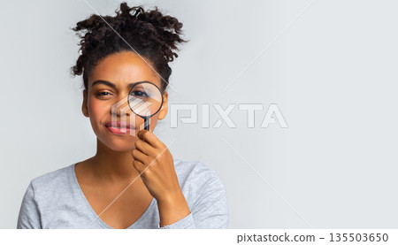 Curious black girl holding magnifier over grey background, panorama with copy space Curious black girl holding magnifier over grey background, panorama with copy space 135503650