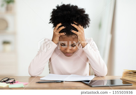 Difficulty Of Home Education. Depressed Teen Girl Having A Hard Time Doing School Homework Online, Touching Head Sitting Indoors Difficulty Of Home Education. Depressed Teen Girl Having A Hard Time Doing School Homework Online, Touching Head Sitting Indoors 135503936