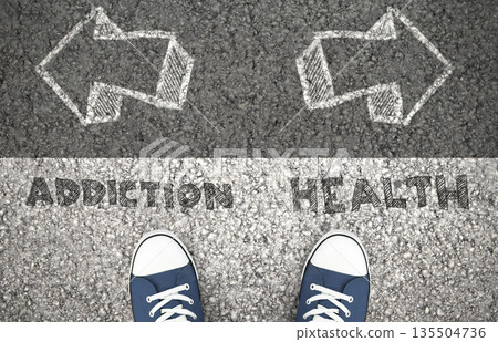 Recovery Concept, Addiction Or Health Written On The Asphalt Road. Above view of feet on the ground Recovery Concept, Addiction Or Health Written On The Asphalt Road. Above view of feet on the ground 135504736