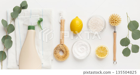 Eco cleaning household background. Cleaning products flat lay, baking soda, lemon vinegar and bamboo brush on white background, panorama 135504825