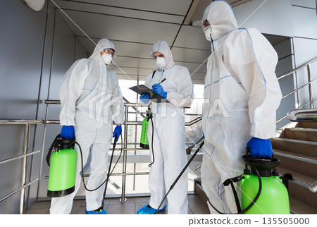Outdoor disinfection by cleaning workers in hazmat suits, surface treatment from coronavirus, steam disinfection 135505000