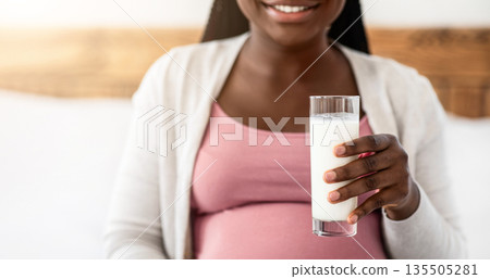 Pregnant African American Woman Enjoying Glass Of Milk At Home, Happy Black Expectant Lady Drinking Healthy Calcium Drink And Smiling, Relaxing In Bedroom, Cropped Image With Free Space, Closeup Pregnant African American Woman Enjoying Glass Of Milk At Home, Happy Black Expectant Lady Drinking Healthy Calcium Drink And Smiling, Relaxing In Bedroom, Cropped Image With Free Space, Closeup 135505281
