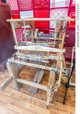 Weaving wooden machine or household weaving for weaving traditional linen. Weaving loom for homemade textile production Weaving wooden machine or household weaving for weaving traditional linen. Weaving loom for homemade textile production 135505325
