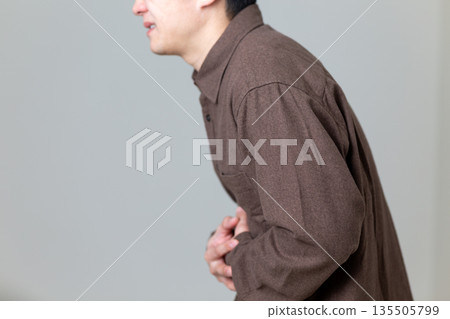 Middle-aged man suffering from stomach pain Middle-aged man suffering from stomach pain 135505799