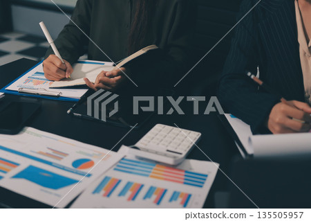 business people in meeting discussing plans together 135505957