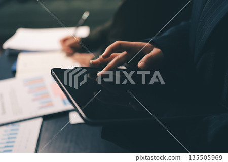 business people in meeting discussing plans together 135505969