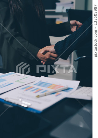 Young business people shaking hands in the office. Finishing successful meeting. Three persons. Wide screen panoramic 135505987
